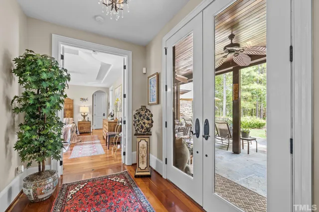 a spacious bathroom with a tub sink and mirror