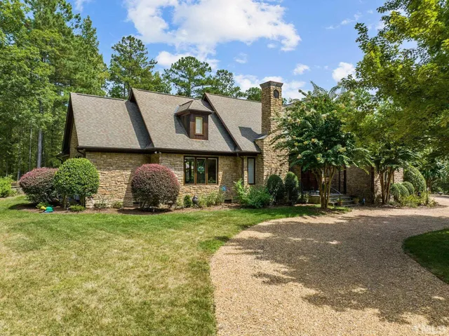 a living room with furniture fireplace and a table