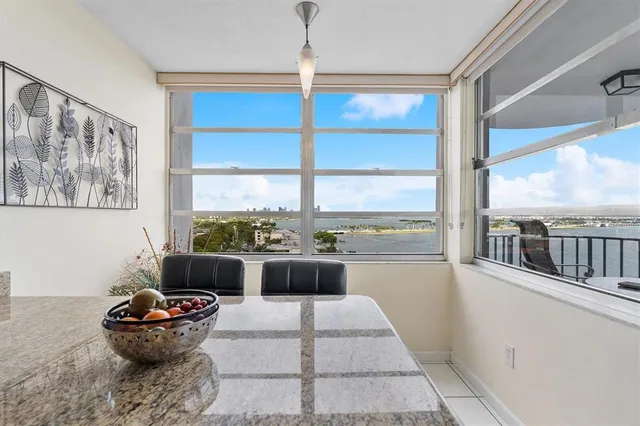 a view of a dining room with furniture a chandelier and wooden floor