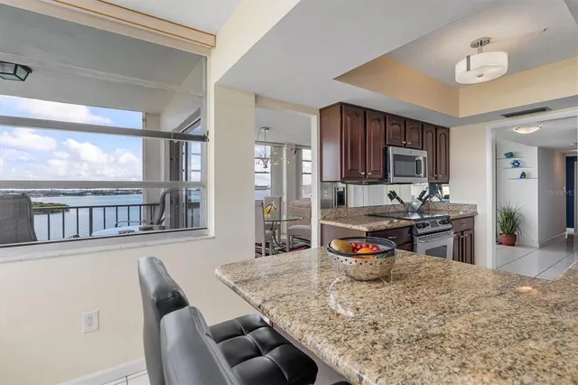 a view of a dining room with furniture a chandelier and wooden floor