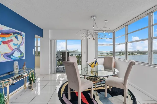 a bedroom with a bed and a large window with a flat tv screen