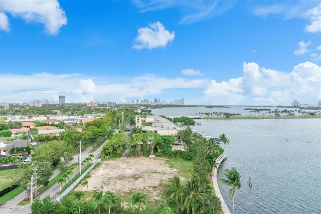 a view of a room that has a bed chair and a window