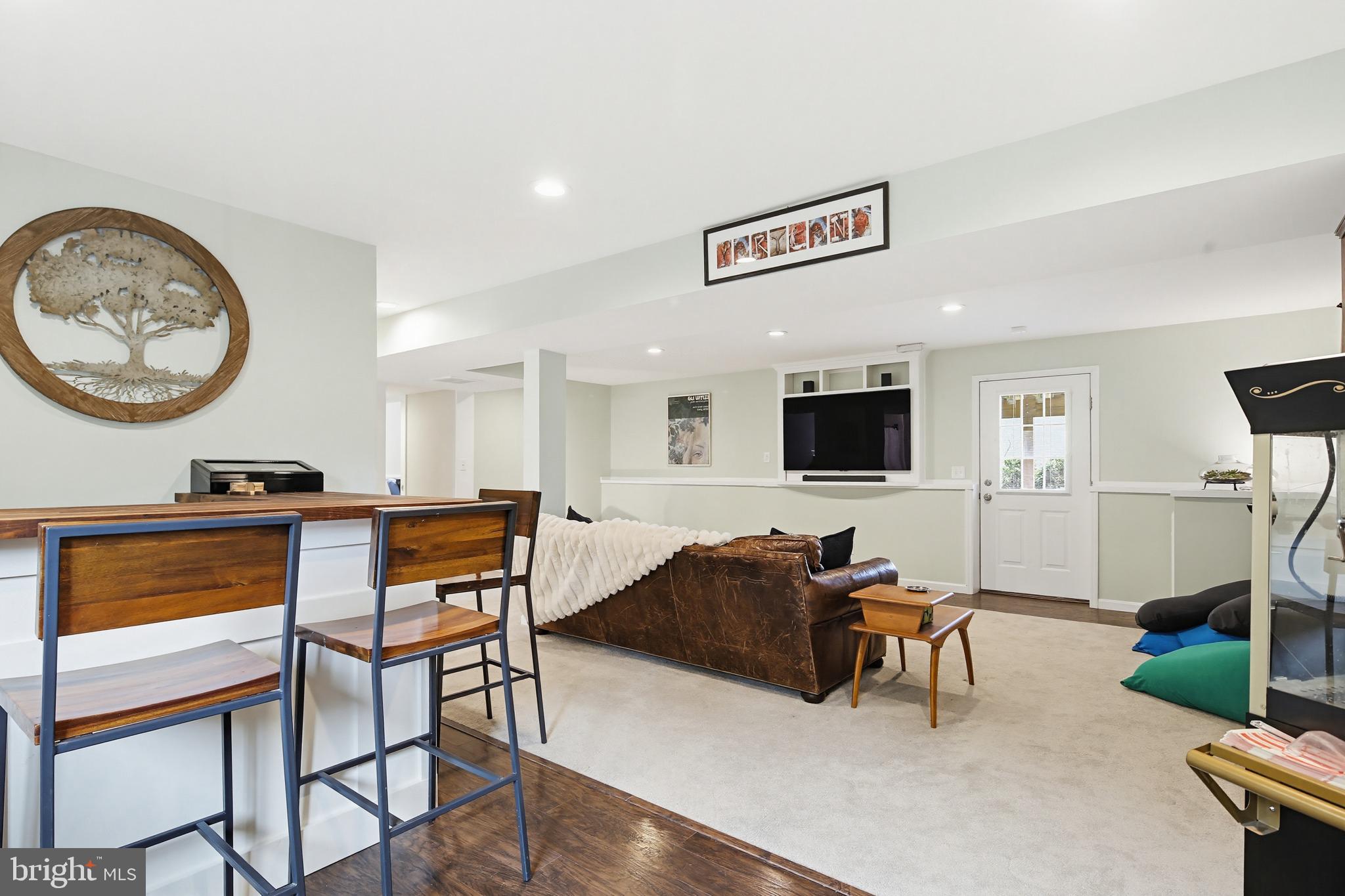 3229 Beards Point Road Davidsonville, MD 21035 - Photo 66 of 69 a living room with furniture a flat screen tv and a wall painting
