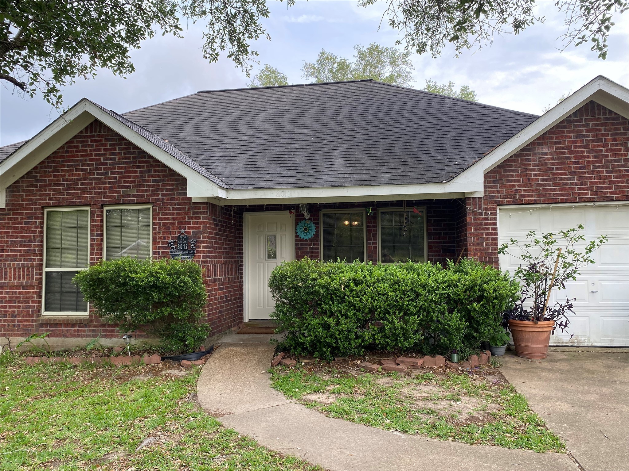 front view of house with potted plants