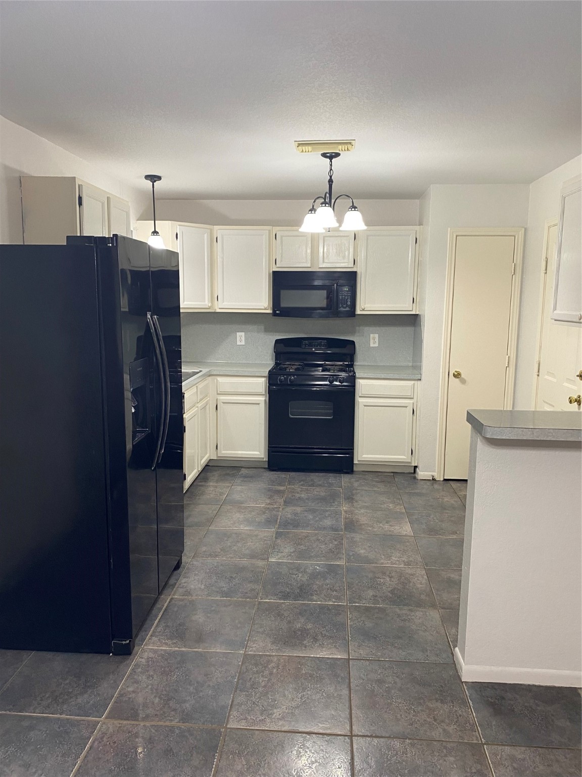8012 Folkstone Lane Houston, TX 77075 - Photo 2 of 6 a kitchen with a refrigerator and a stove