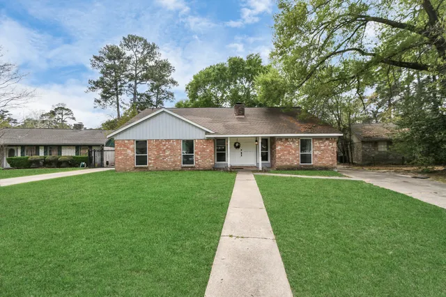 a front view of a house with a yard and porch