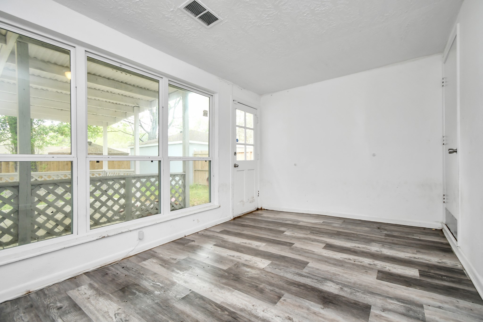 22723 Earlmist Drive Spring, TX 77373 - Photo 16 of 20 a view of an empty room with wooden floor and a window