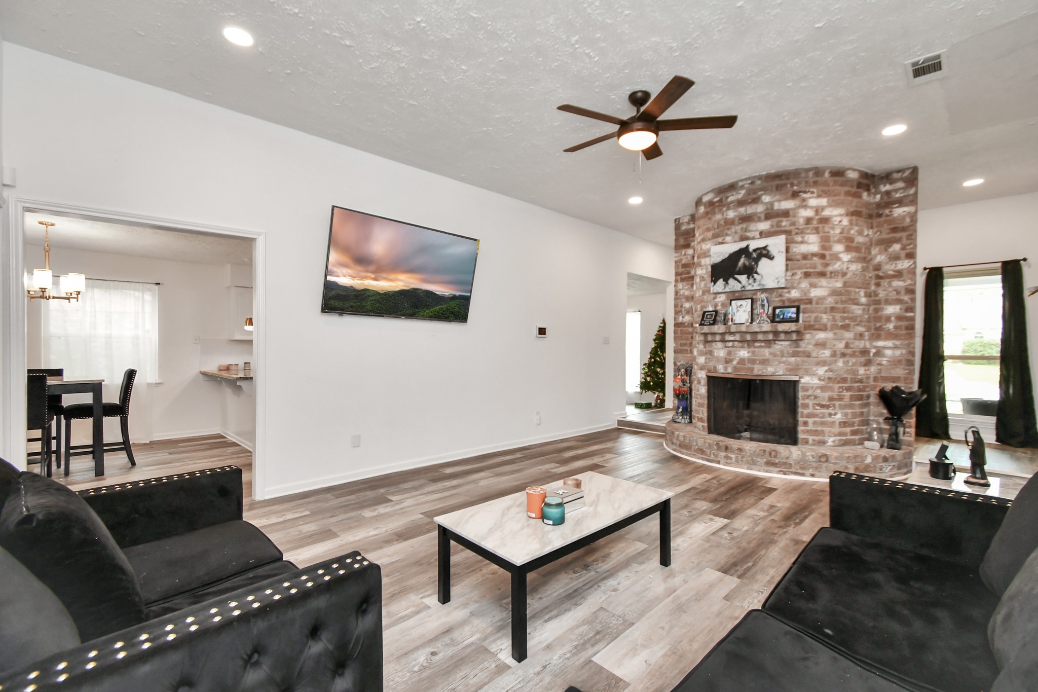 22723 Earlmist Drive Spring, TX 77373 - Photo 3 of 20 a living room with furniture a fireplace and a chandelier