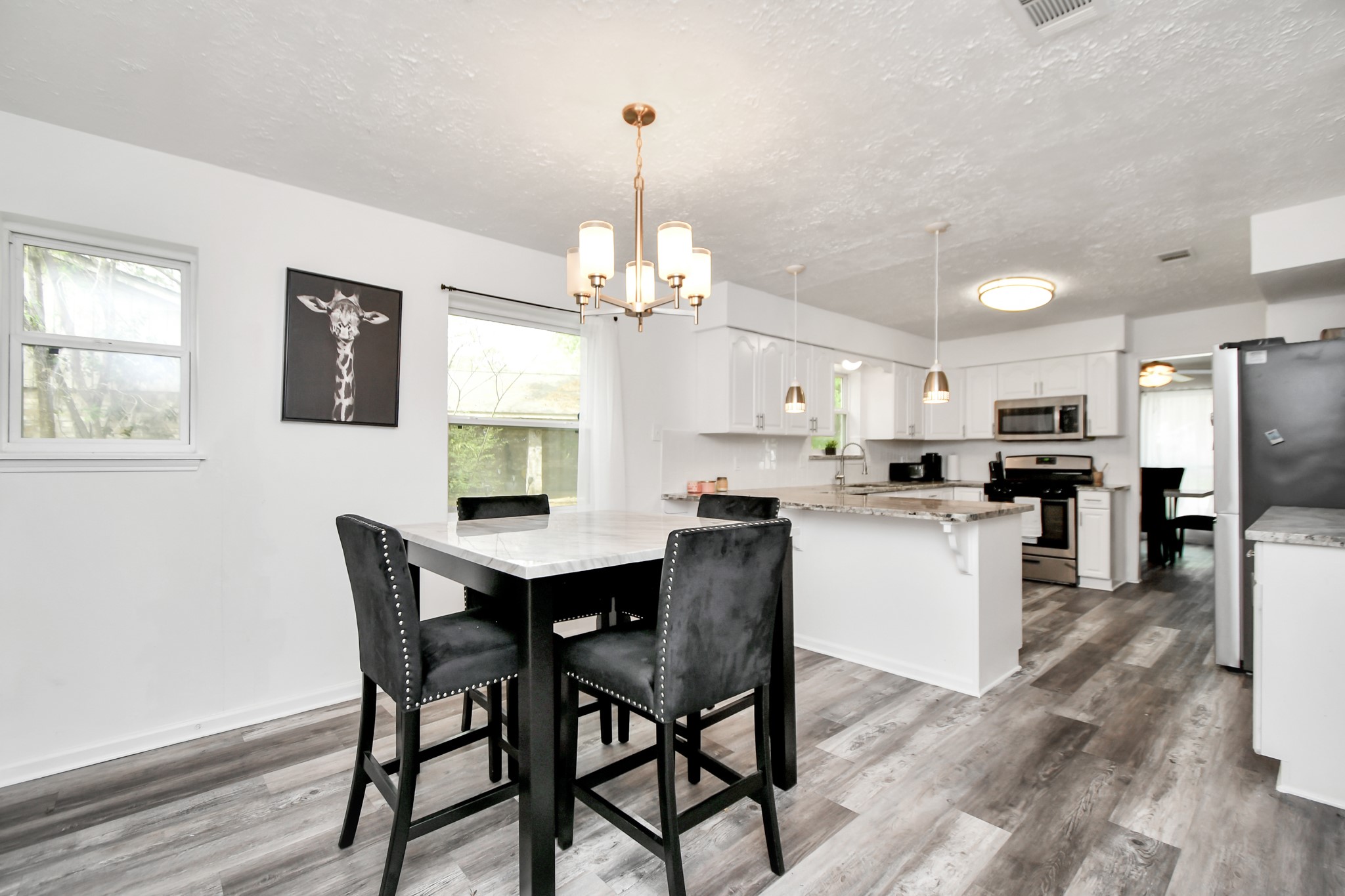 22723 Earlmist Drive Spring, TX 77373 - Photo 5 of 20 a view of a dining room and livingroom with furniture wooden floor a chandelier