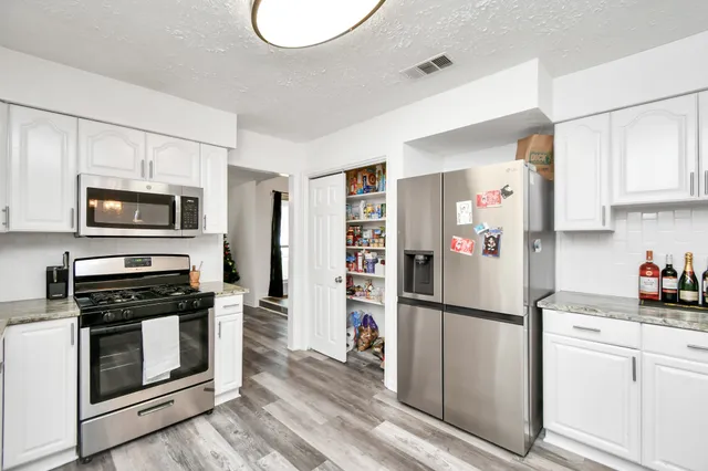 a kitchen with wooden cabinets and stainless steel appliances