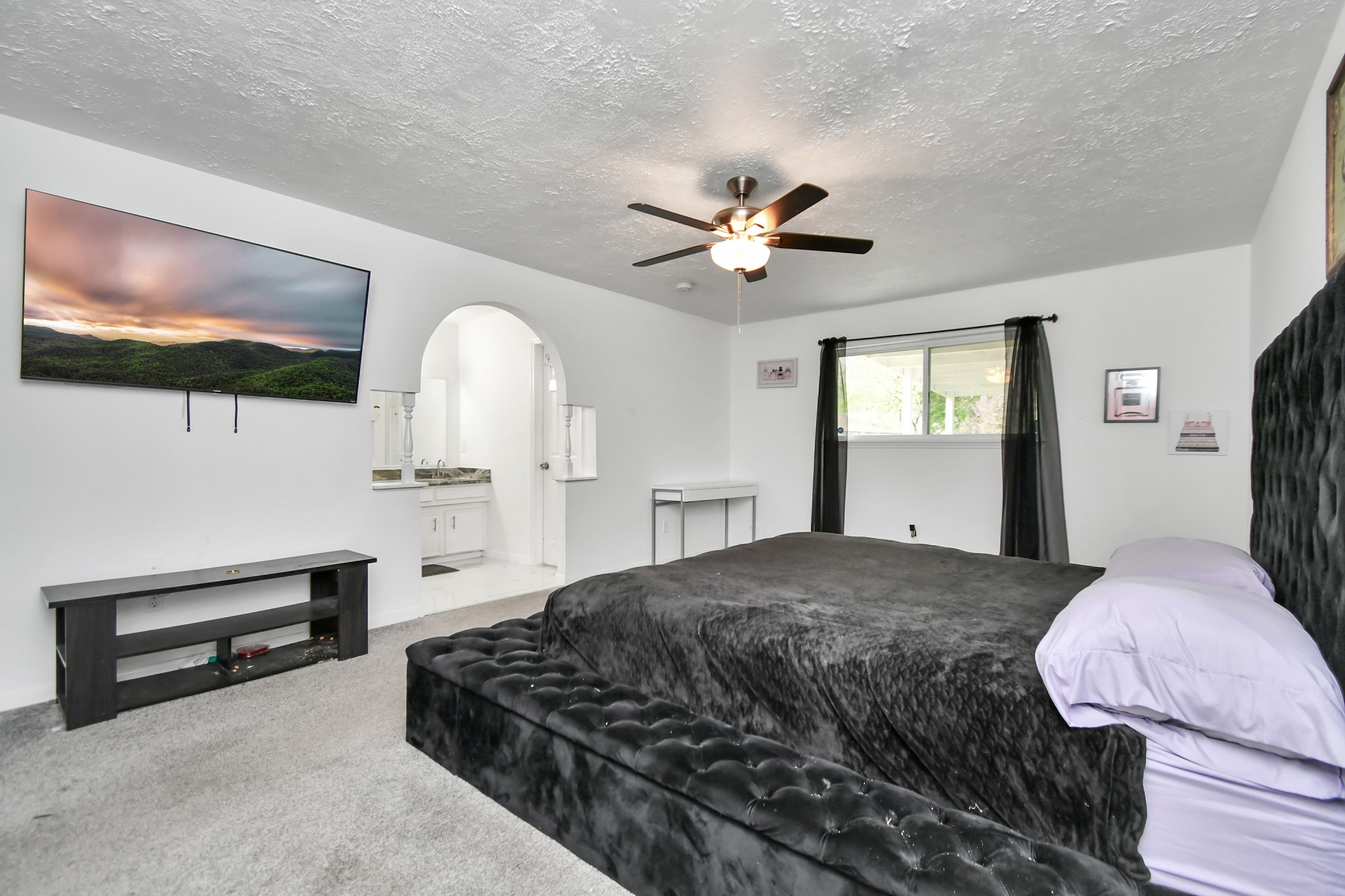 22723 Earlmist Drive Spring, TX 77373 - Photo 9 of 20 a spacious bedroom with a bed and a flat screen tv