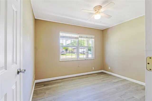 wooden floor in an empty room with a window