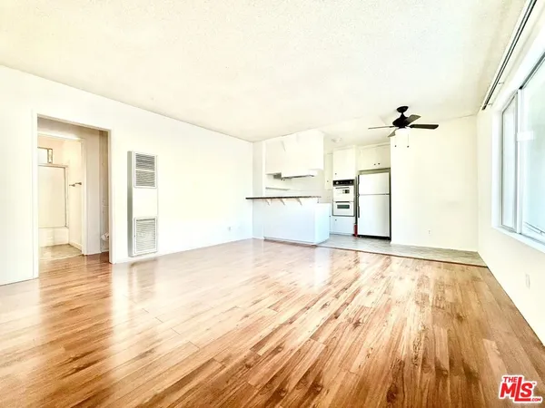 a view of a kitchen with wooden floor and a sink