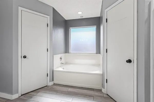 a bathroom with a bathtub and a shower