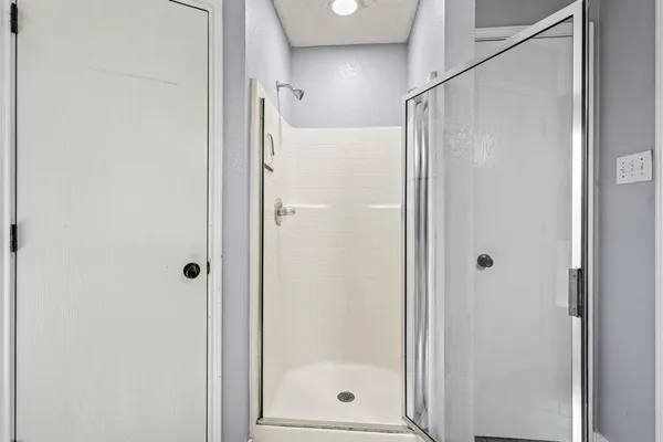 a bathroom with a glass shower door
