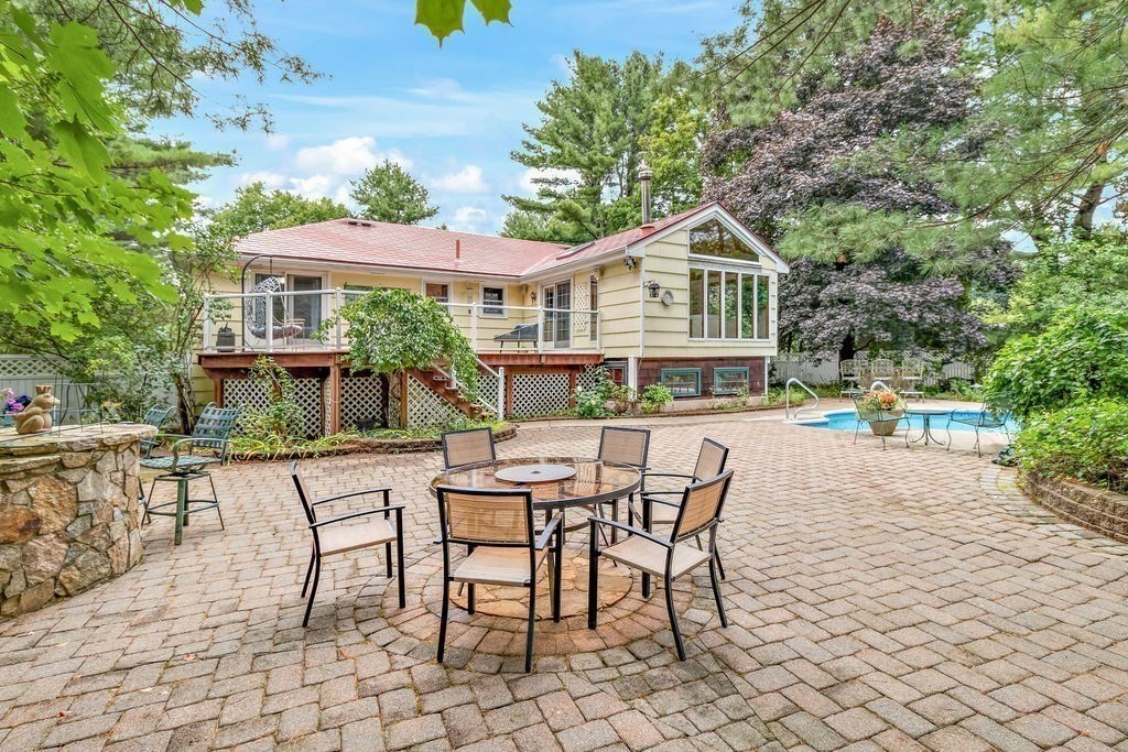 a view of a house with backyard sitting area and garden