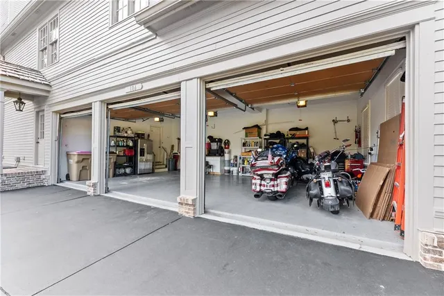 a spacious bedroom with a bed and a flat screen tv