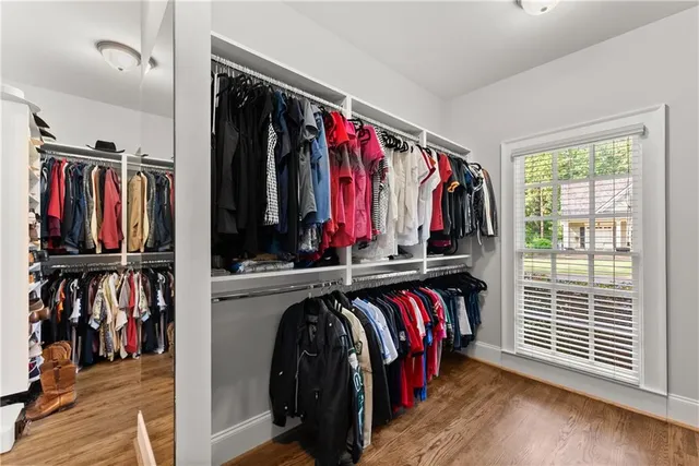 a bathroom with a sink a toilet a mirror and shower