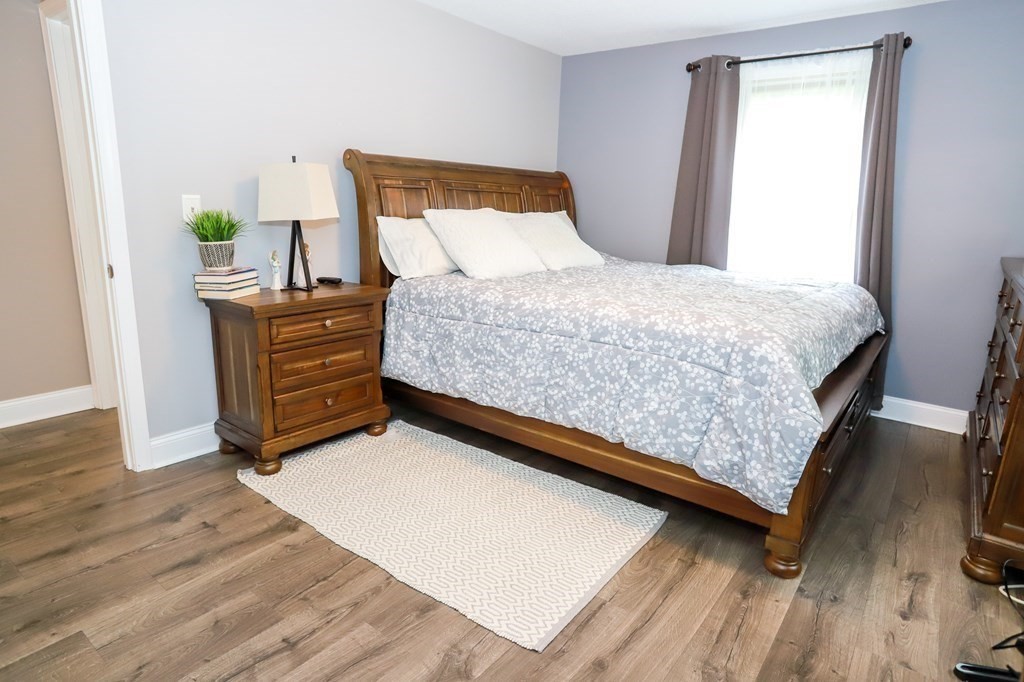 120 Brooks Village Road Templeton, MA 01468 - Photo 28 of 40 a bedroom with a bed and wooden floor