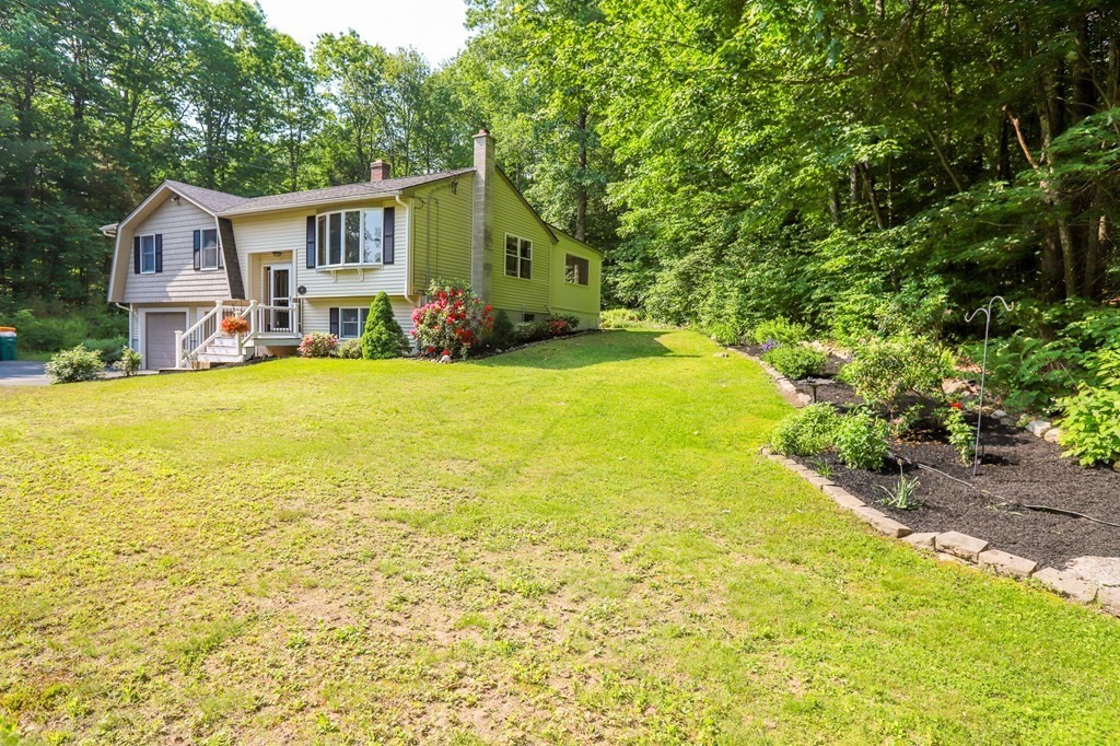 120 Brooks Village Road Templeton, MA 01468 - Photo 4 of 40 a view of a backyard with plants and swimming pool