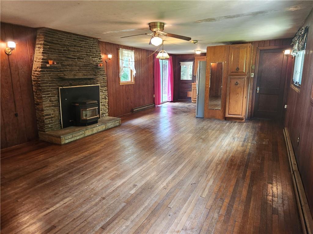 223 South Benbrook Road Butler, PA 16001 - Photo 7 of 31 Large living dining area with a pellet stove and hardwood floors.