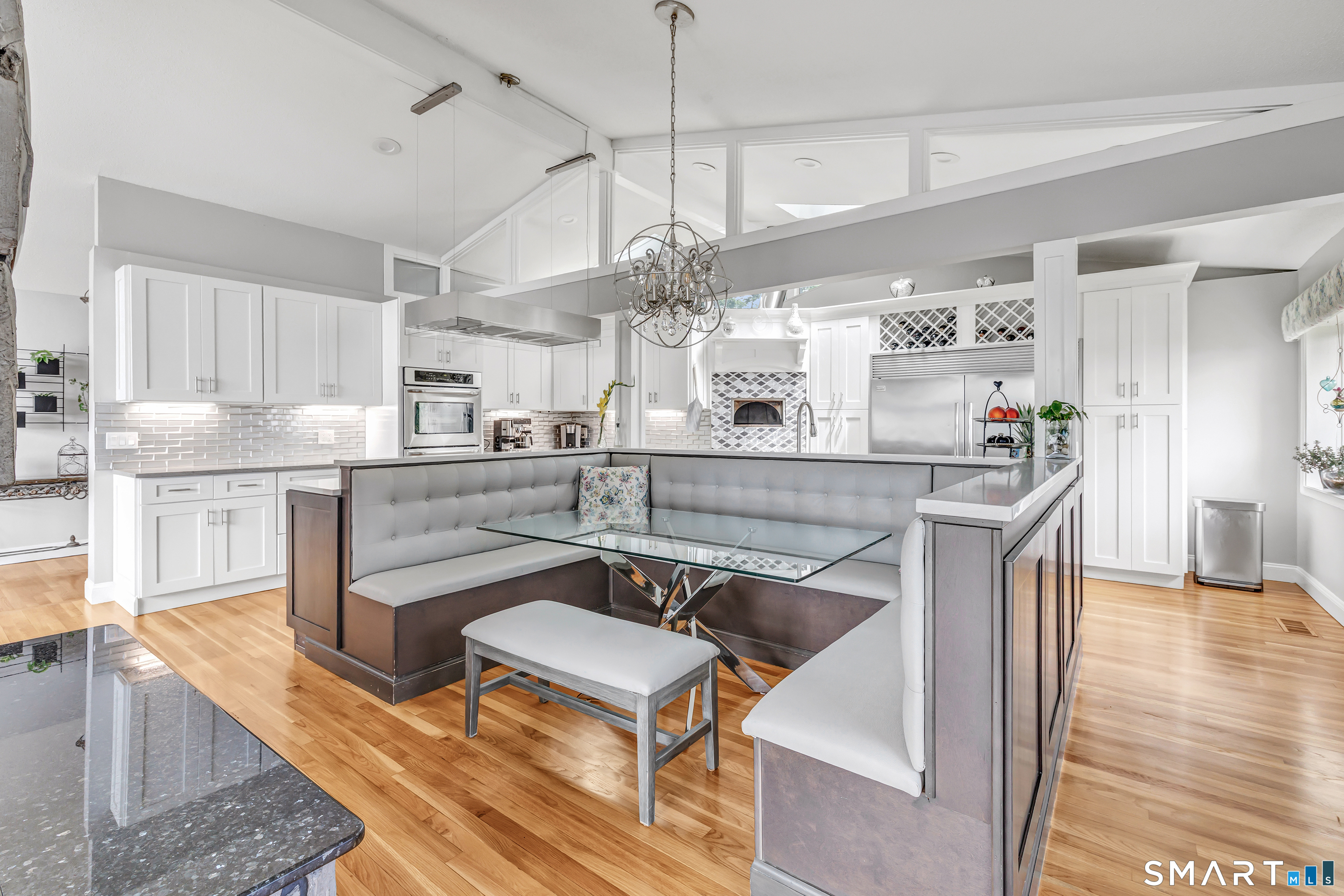 70 North Benham Road Seymour, CT 06483 - Photo 15 of 32 a kitchen with stainless steel appliances kitchen island granite countertop a table chairs in it and wooden floors