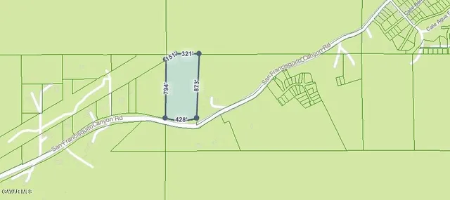 a picture of a field with a building in the background