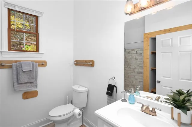 a white toilet sitting next to a bathroom sink