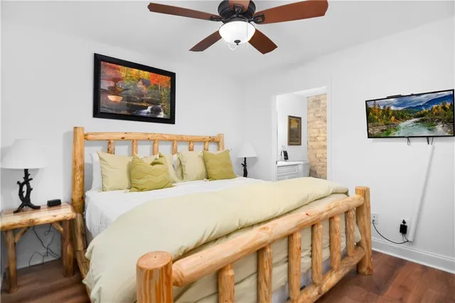 a bedroom with a bed and a painting on the wall