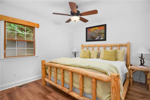 a bedroom with a bed and a large window