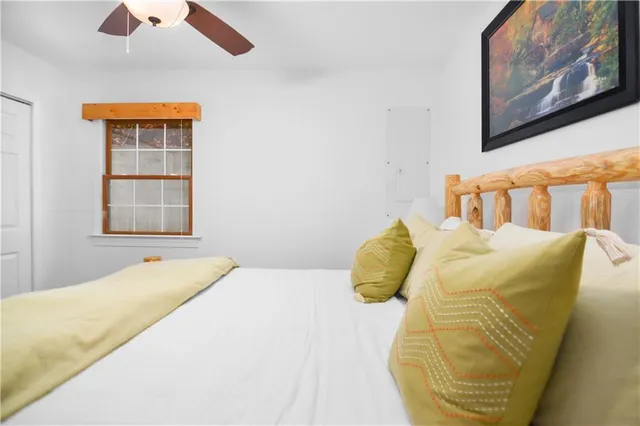 a bedroom with a bed and a painting on the wall