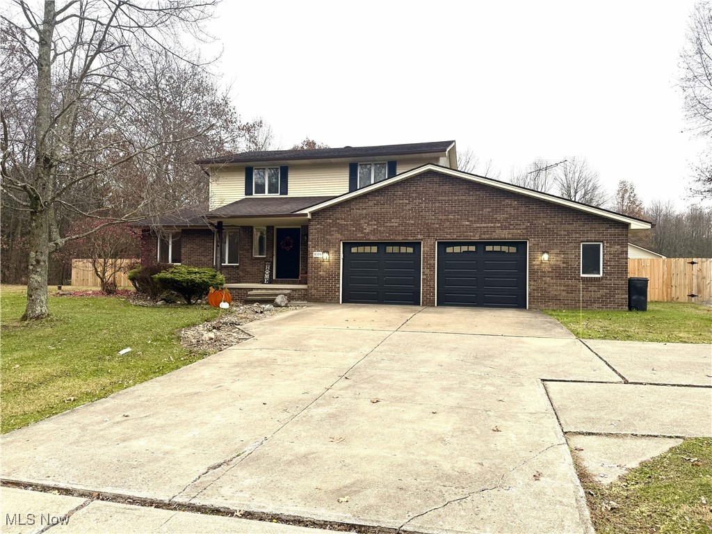 8359 Gibson Road Canfield, OH 44406 - Photo 27 of 27 Traditional home featuring covered porch, brick siding, concrete driveway, and an attached garage
