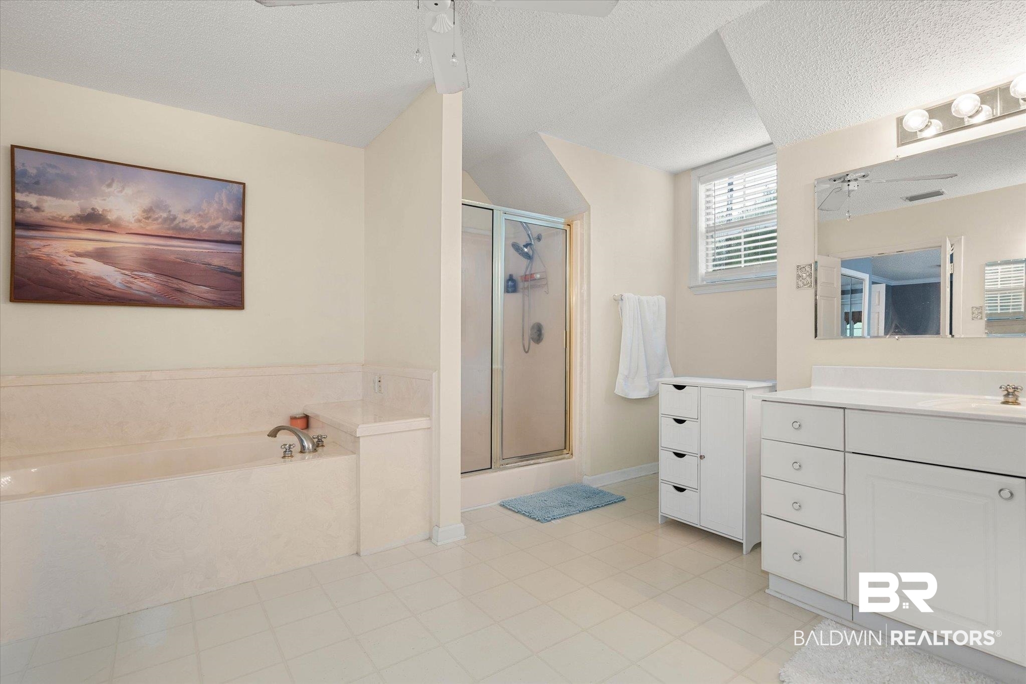 2300 Radcliff Road Saraland, AL 36571 - Photo 26 of 56 Full bath with vanity, a stall shower, a bath, a textured ceiling, and ceiling fan