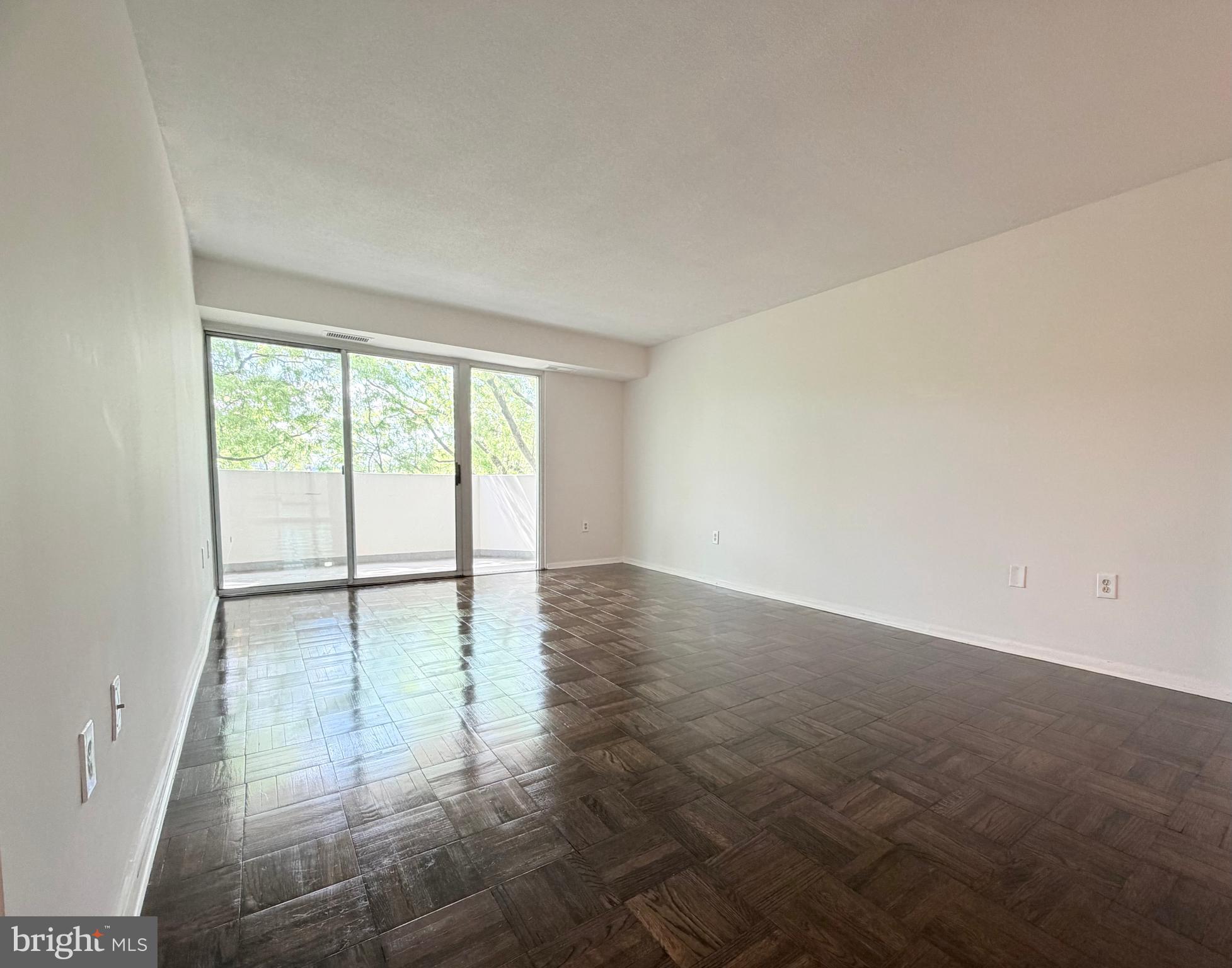 700 7th Street Southwest, Unit 406 Washington, DC 20024 - Photo 13 of 50 an empty room with wooden floor and windows