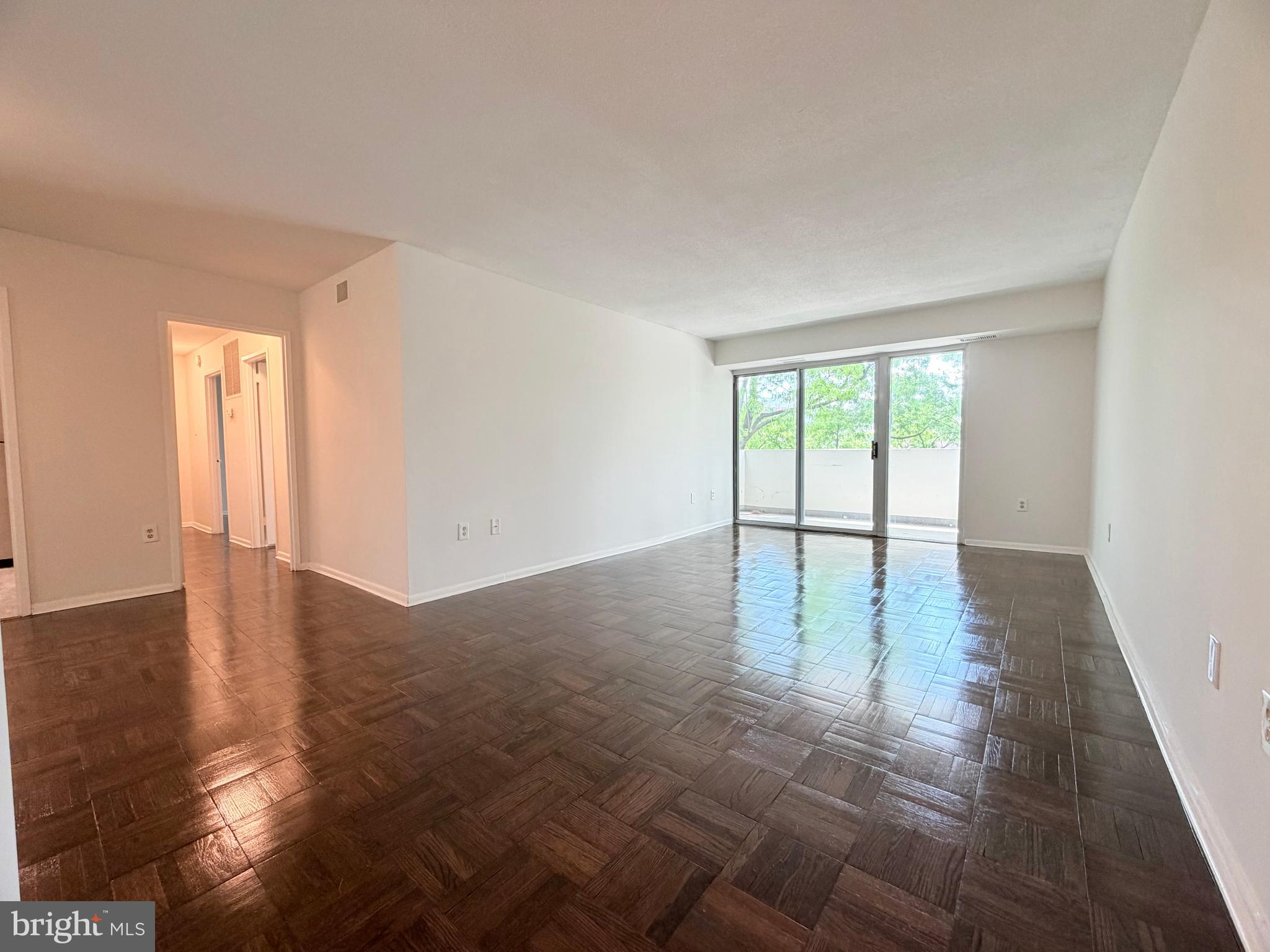 700 7th Street Southwest, Unit 406 Washington, DC 20024 - Photo 14 of 50 an empty room with wooden floor and windows