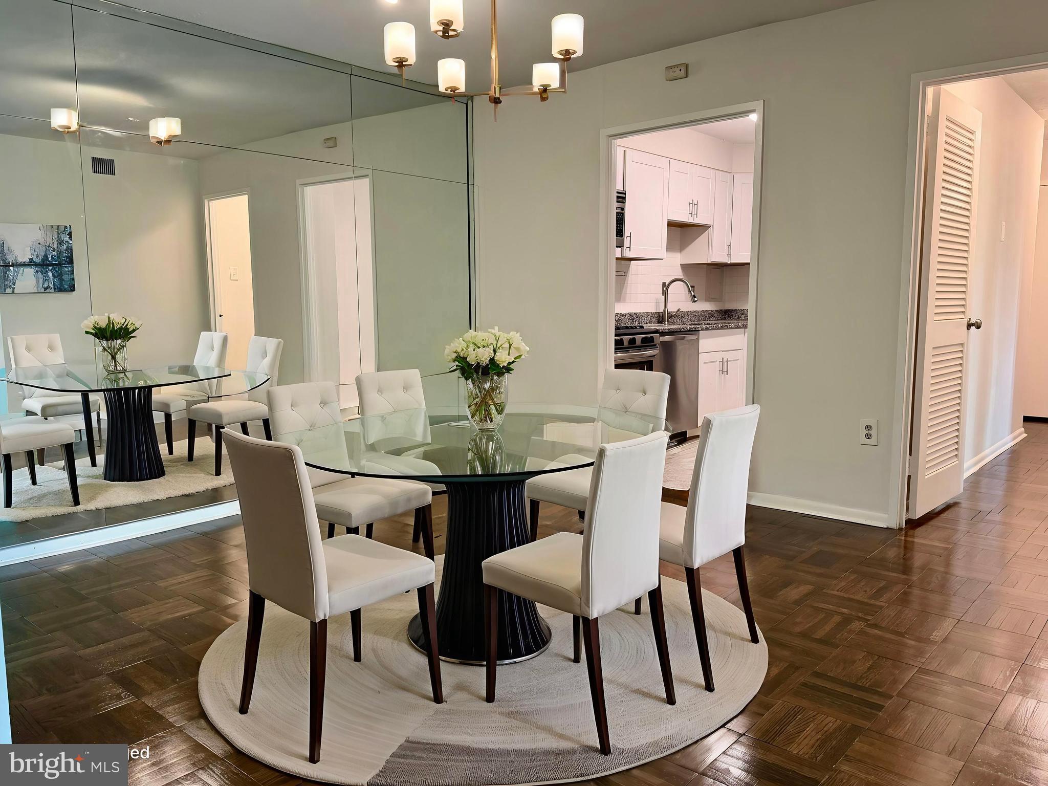 700 7th Street Southwest, Unit 406 Washington, DC 20024 - Photo 15 of 50 a dining room with furniture a chandelier and wooden floor