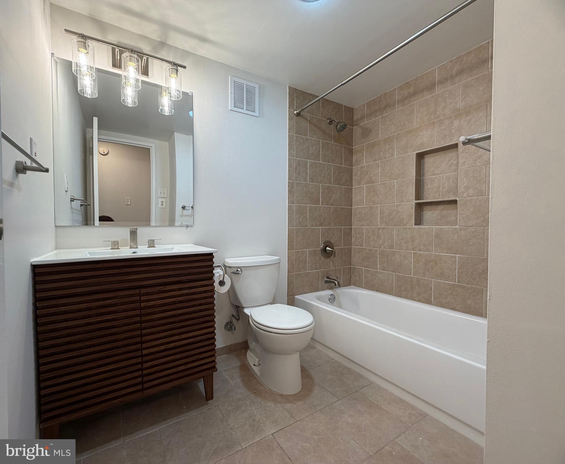 700 7th Street Southwest, Unit 406 Washington, DC 20024 - Photo 27 of 50 a bathroom with a sink a toilet and shower
