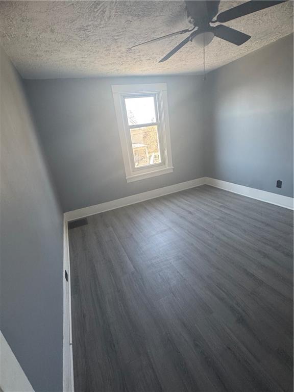 546 Ridge Avenue New Kensington, PA 15068 - Photo 11 of 14 an empty room with wooden floor chandelier fan and windows