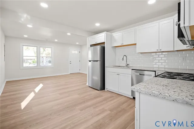 a kitchen that has a sink a stove and refrigerator