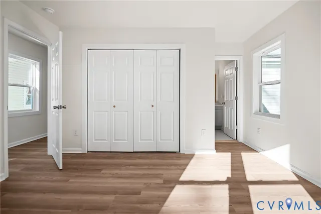 a view of a room with wooden floor and windows