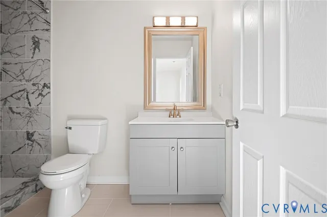 a bathroom with a sink a toilet and mirror