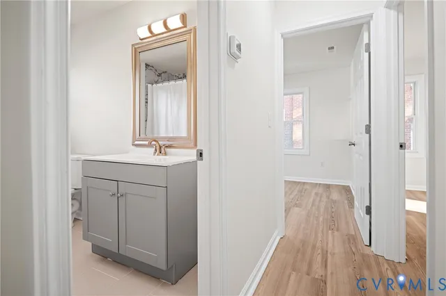 a bathroom with a sink vanity and a mirror