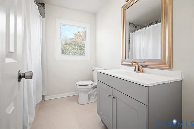 a bathroom with a sink toilet and a mirror