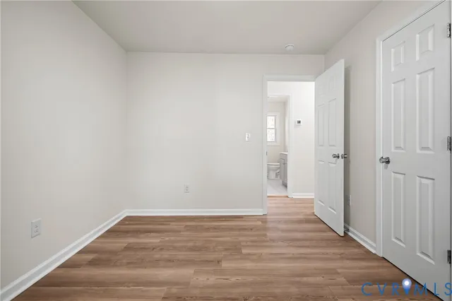 a view of a room with wooden floor