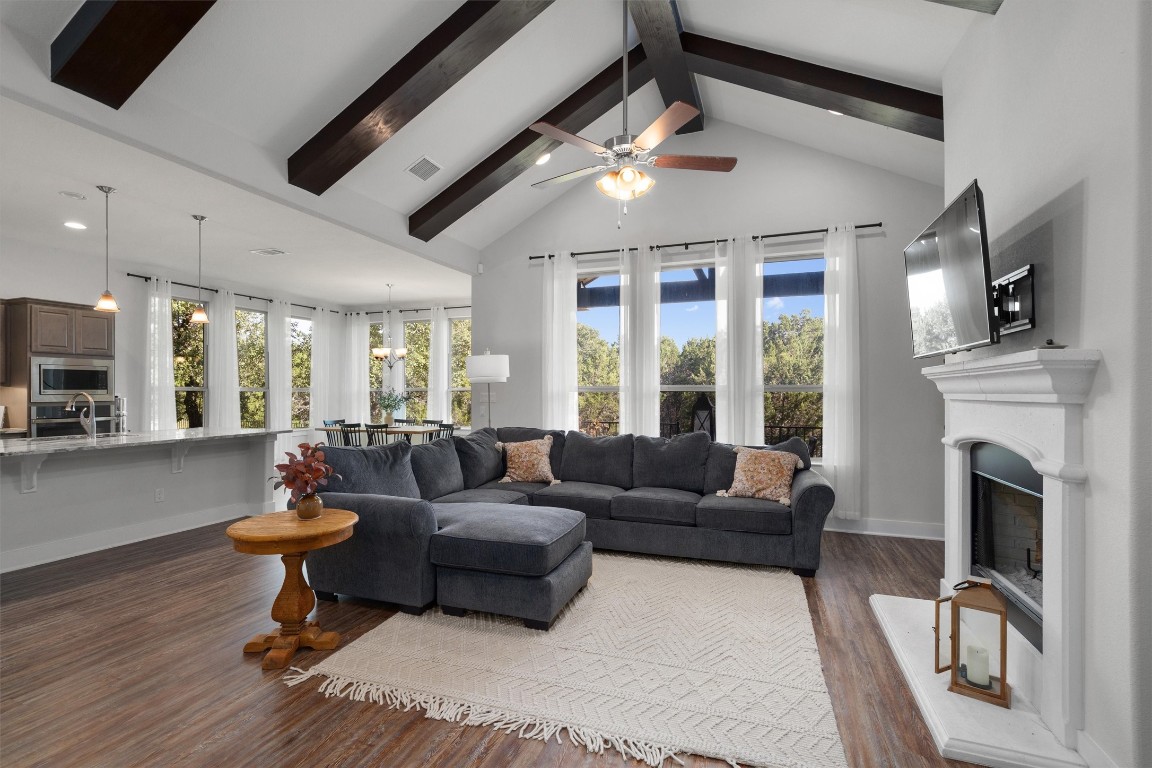 a living room with furniture a fireplace and a flat screen tv