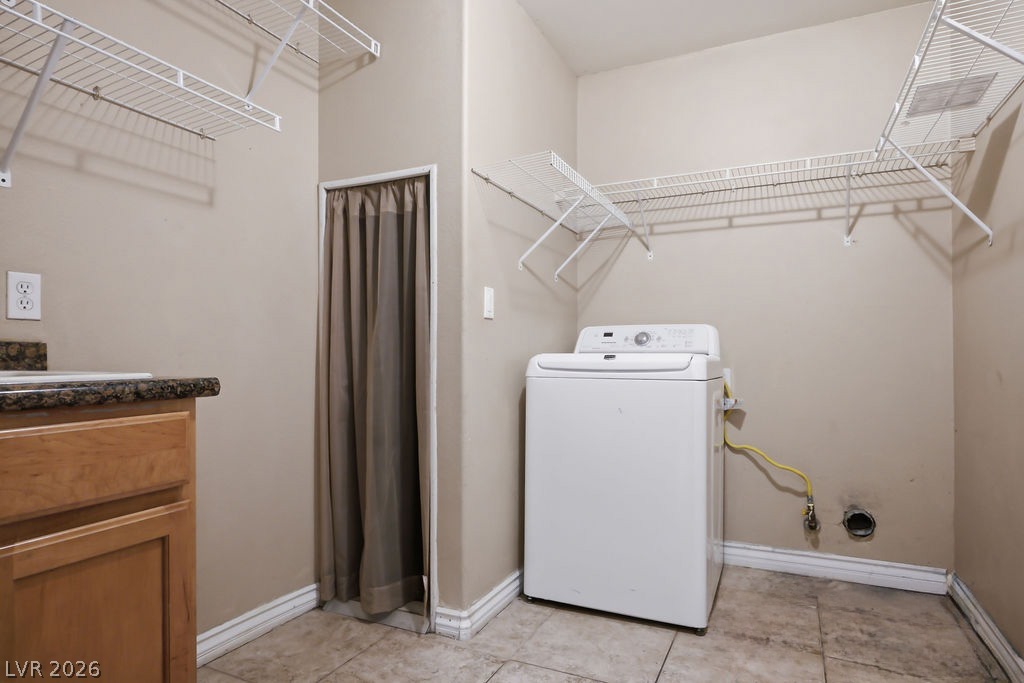 9712 North Running Rabbit Street Las Vegas, NV 89143 - Photo 22 of 42 Functional laundry space featuring a washer and convenient overhead wire shelving.