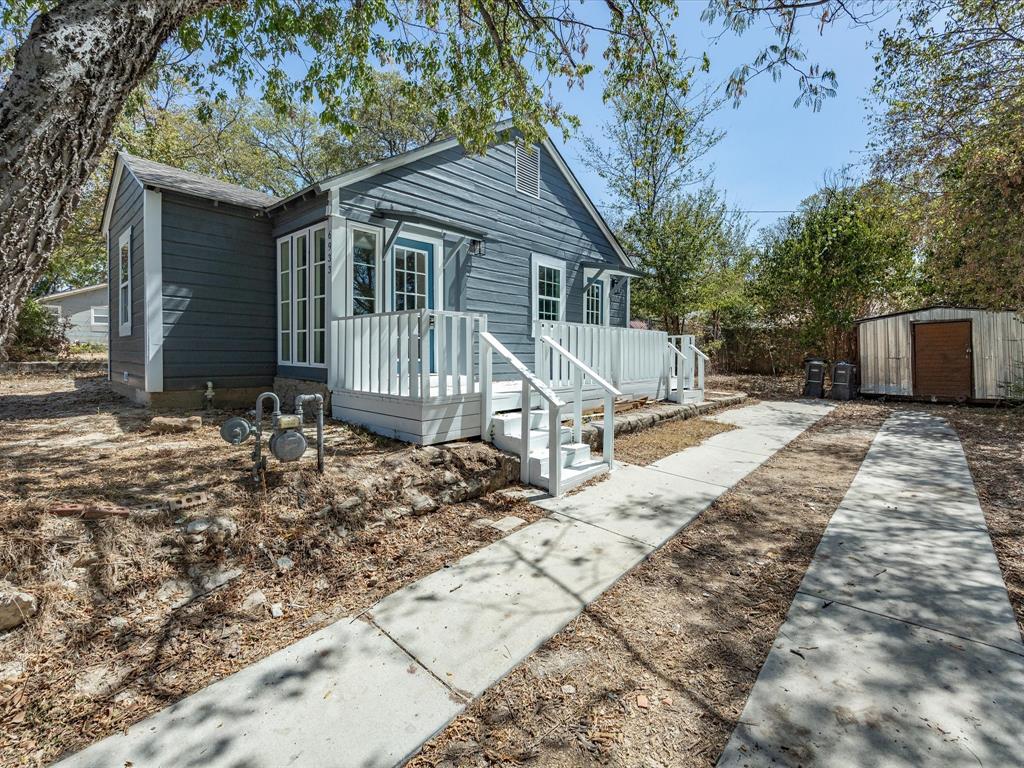 6933 Hatch Road Lake Worth, TX 76135 - Photo 4 of 28 Exterior featuring blue siding, white window trim, a white porch with steps, and an adjacent concrete driveway