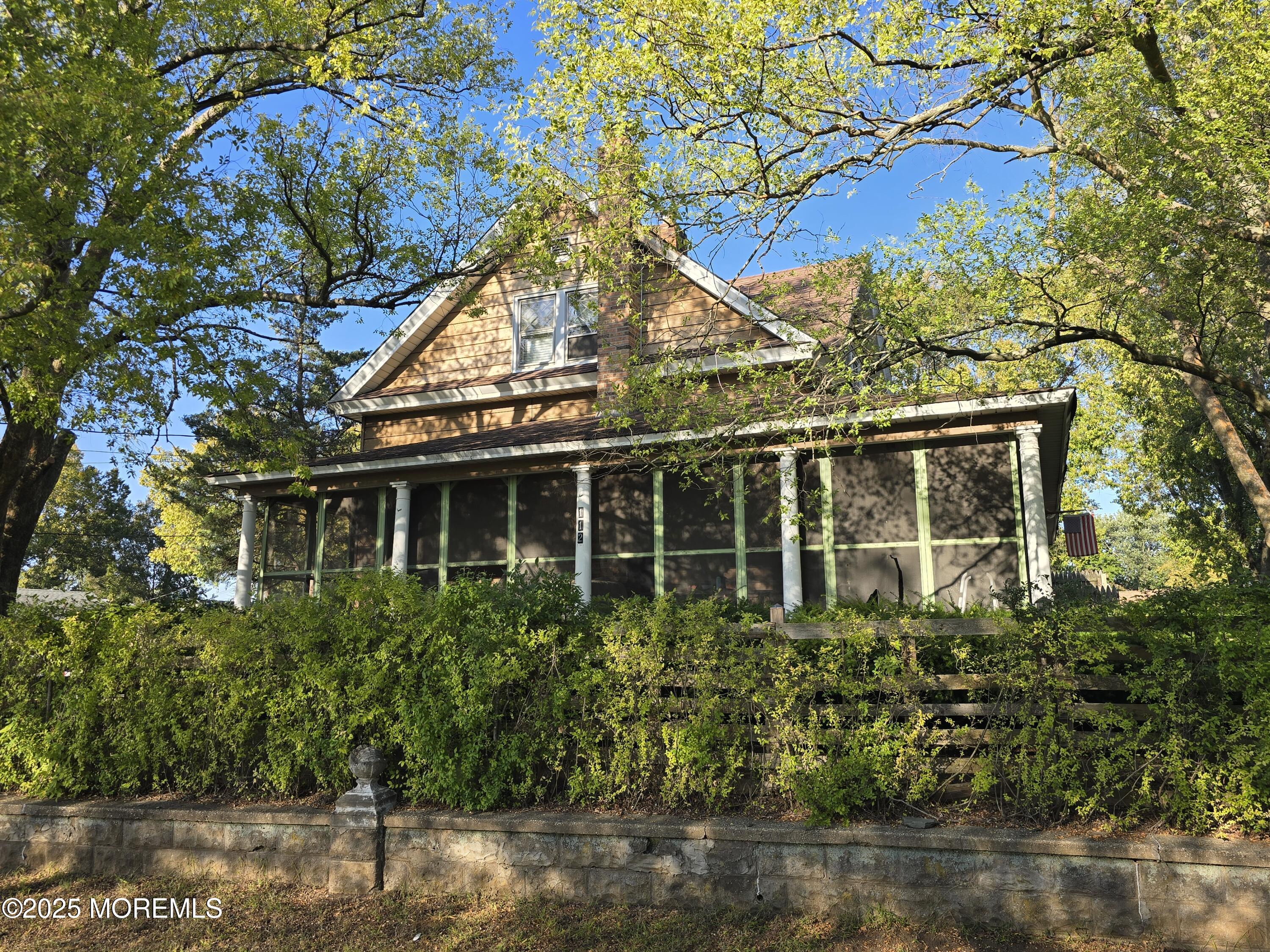 112 Creek Road Keansburg, NJ 07734 - Photo 5 of 9 a view of a house with brick walls and flower plants