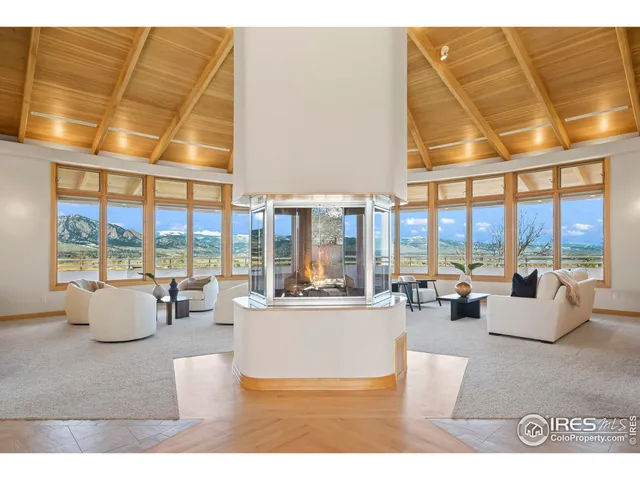a living room with furniture and large windows