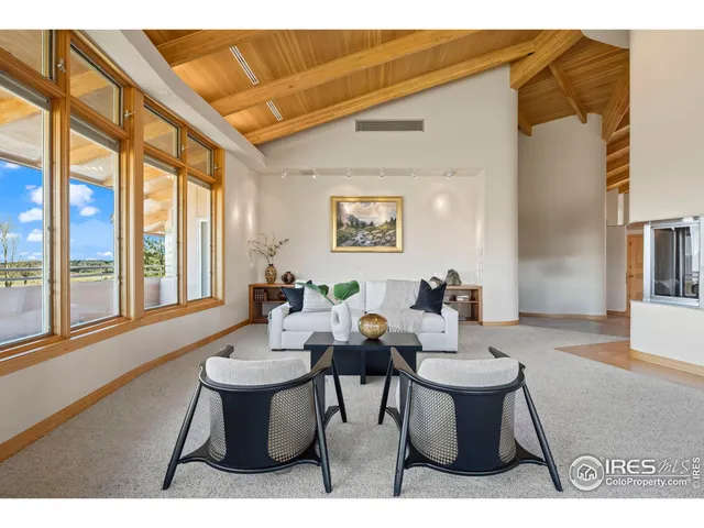 a view of a dining room with furniture large windows and wooden floor